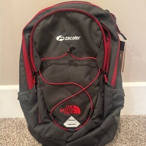 The North Face Gray and Red Backpack with Bungee Detail